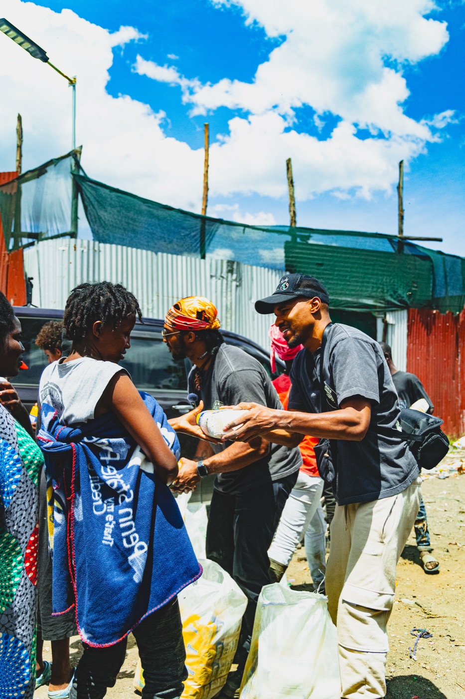 Participant handing supplies to a community member